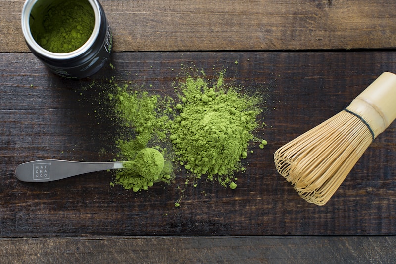 Green powder and spoon on board