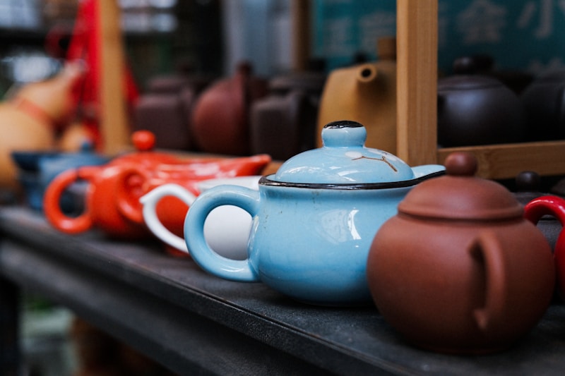 A row of colorful teapots on a shelf