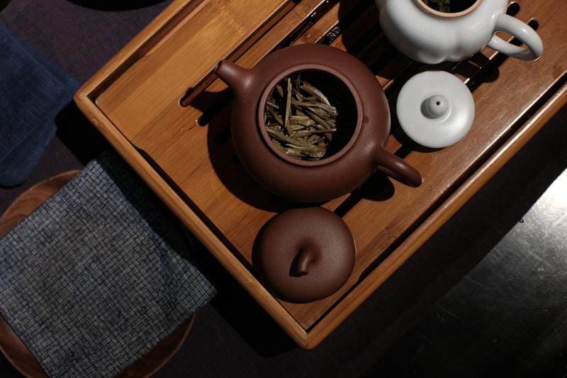 Tea set with teapot and cups on wooden tray